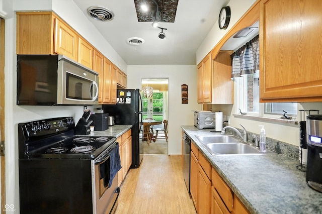 4340 Ashbourne Ln, Indianapolis, IN 46226 - kitchen featuring appliances with stainless steel finishes, light wood-style floors, and light countertops