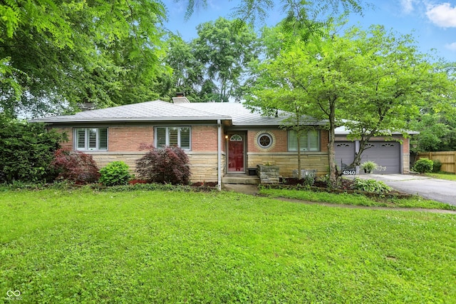 4340 Ashbourne Ln, Indianapolis, IN 46226 - view of front of home featuring asphalt driveway, a garage, brick siding, a chimney, and stone siding