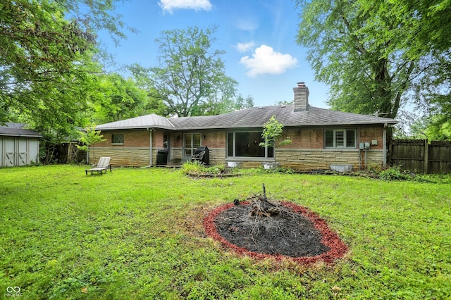 4340 Ashbourne Ln, Indianapolis, IN 46226 - rear view of property featuring stone siding, a chimney, and a storage unit