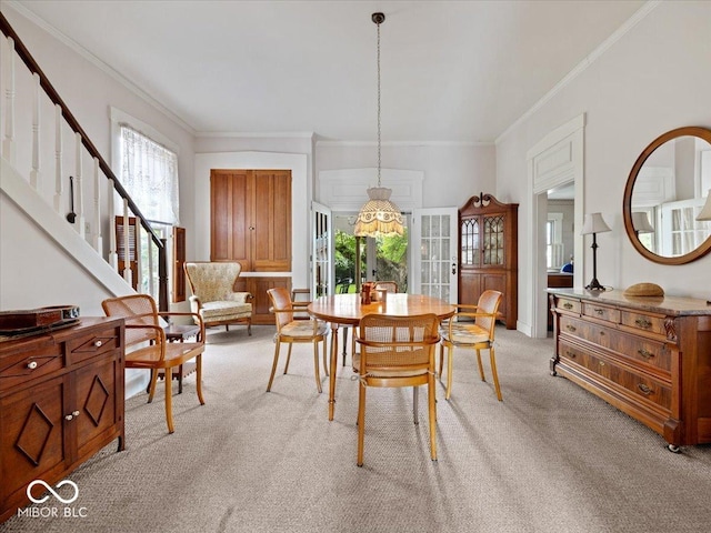 228 W Washington St, Shelbyville, IN 46176 - dining space with light carpet, crown molding, and stairway