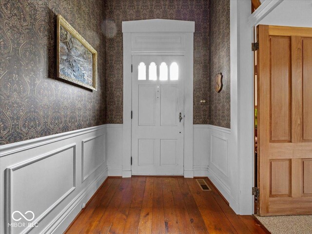 228 W Washington St, Shelbyville, IN 46176 - entryway featuring wallpapered walls, a wainscoted wall, and hardwood / wood-style floors