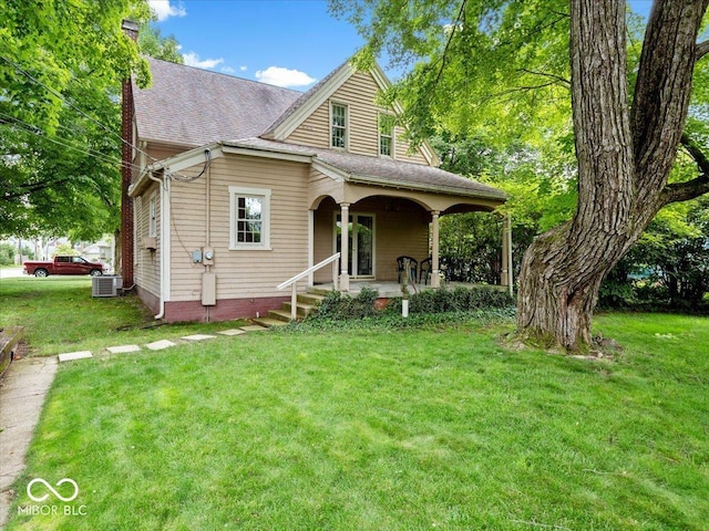 228 W Washington St, Shelbyville, IN 46176 - view of front of home featuring a porch, a front yard, a chimney, and a shingled roof