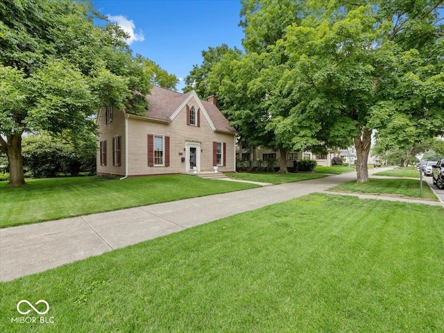 228 W Washington St, Shelbyville, IN 46176 - colonial inspired home with a front lawn and a chimney