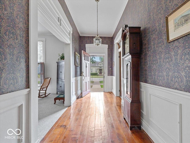 228 W Washington St, Shelbyville, IN 46176 - entrance foyer with wallpapered walls, a wainscoted wall, and light wood-style floors