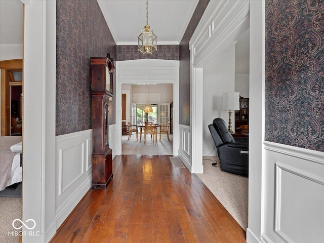228 W Washington St, Shelbyville, IN 46176 - foyer with hardwood / wood-style flooring, a wainscoted wall, ornamental molding, a chandelier, and wallpapered walls