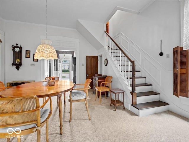 228 W Washington St, Shelbyville, IN 46176 - dining area featuring light carpet, stairs, and crown molding