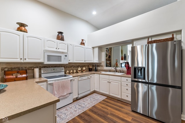564 Parkhurst Ct, Greenwood, IN 46142 - kitchen with white appliances, lofted ceiling, backsplash, white cabinets, and recessed lighting