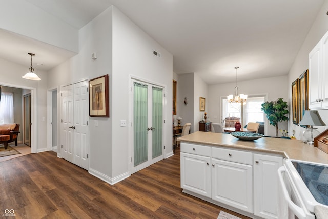 564 Parkhurst Ct, Greenwood, IN 46142 - kitchen featuring a peninsula, white cabinetry, dark wood-style floors, and a chandelier