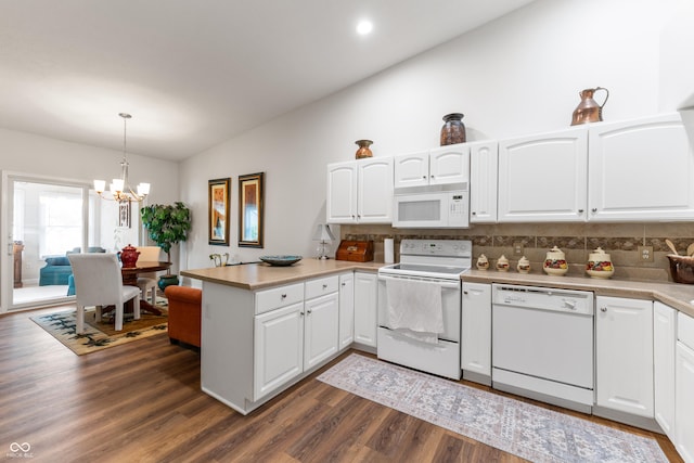 564 Parkhurst Ct, Greenwood, IN 46142 - kitchen with white appliances, vaulted ceiling, a peninsula, tasteful backsplash, and white cabinets