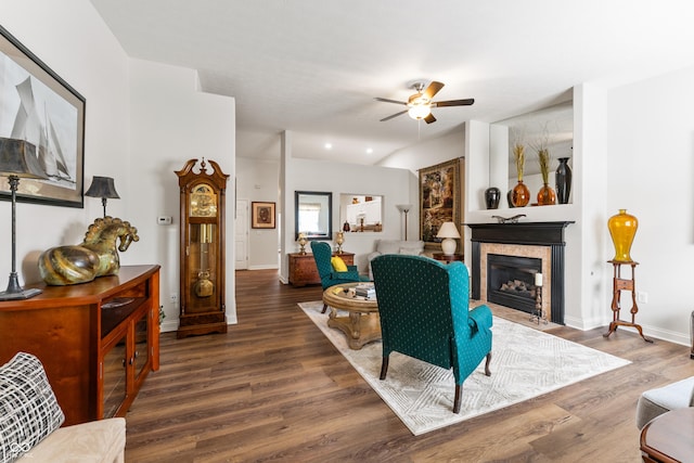 564 Parkhurst Ct, Greenwood, IN 46142 - living area featuring a ceiling fan, wood finished floors, a fireplace with flush hearth, and vaulted ceiling