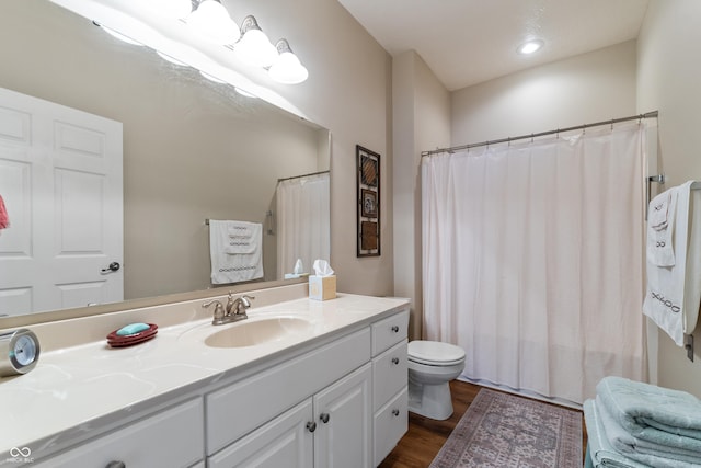 564 Parkhurst Ct, Greenwood, IN 46142 - bathroom featuring wood finished floors, vanity, and curtained shower