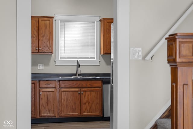 1310 California St, Columbus, IN 47201 - kitchen with dark countertops, wood finished floors, brown cabinets, and stainless steel dishwasher
