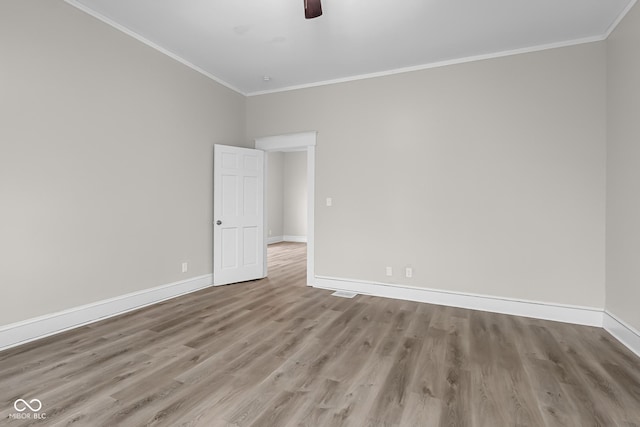 1310 California St, Columbus, IN 47201 - empty room featuring wood finished floors, ornamental molding, and ceiling fan