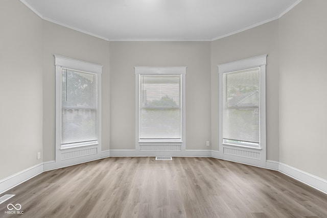 1310 California St, Columbus, IN 47201 - unfurnished room featuring wood finished floors, crown molding, and healthy amount of natural light