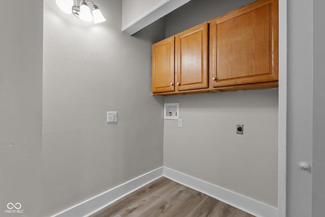 1310 California St, Columbus, IN 47201 - laundry area with washer hookup, cabinet space, wood finished floors, and hookup for an electric dryer