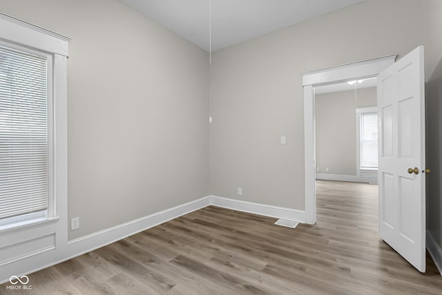1310 California St, Columbus, IN 47201 - empty room with wood finished floors and baseboards