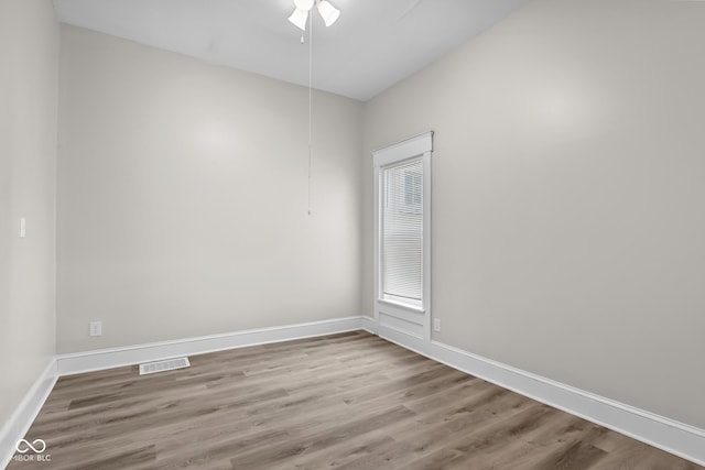 1310 California St, Columbus, IN 47201 - spare room with wood finished floors and a ceiling fan