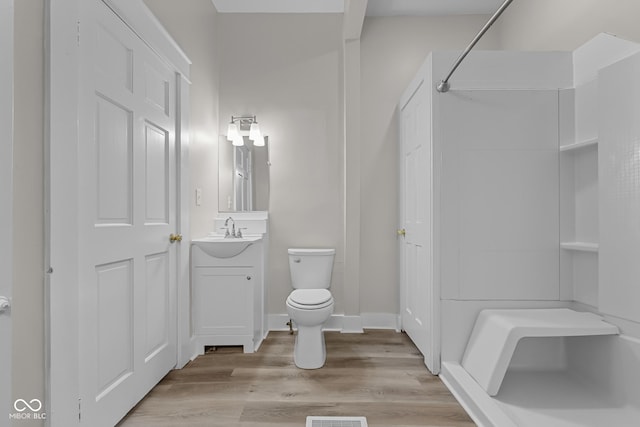 1310 California St, Columbus, IN 47201 - bathroom featuring vanity, a shower, and wood finished floors