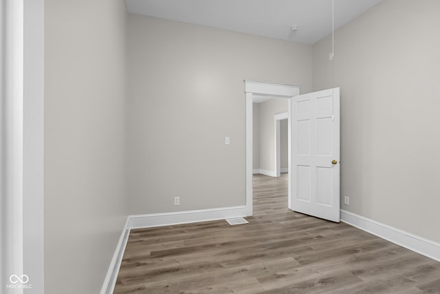 1310 California St, Columbus, IN 47201 - empty room featuring wood finished floors and baseboards
