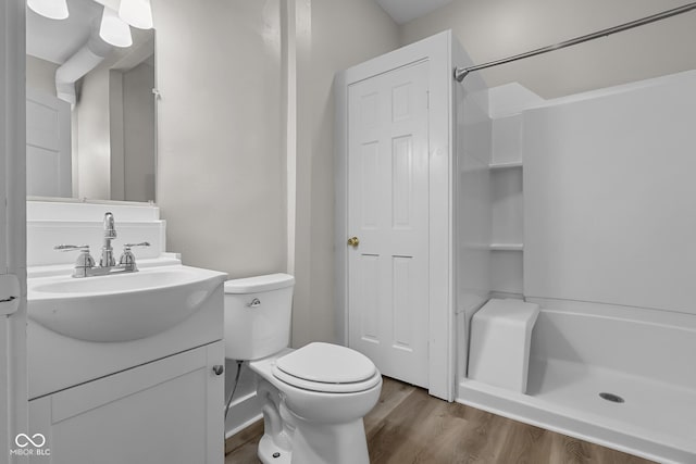 1310 California St, Columbus, IN 47201 - bathroom featuring a shower, vanity, and wood finished floors