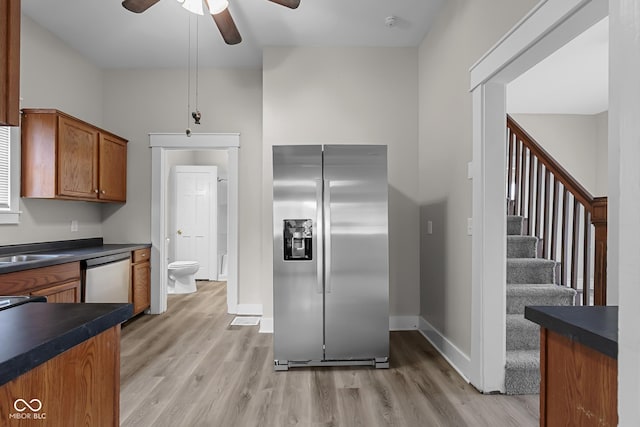1310 California St, Columbus, IN 47201 - kitchen featuring stainless steel appliances, light wood-style flooring, ceiling fan, and dark countertops