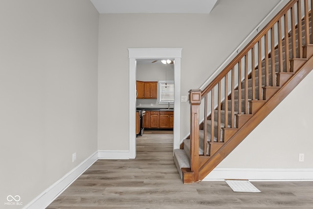 1310 California St, Columbus, IN 47201 - stairs featuring wood finished floors and a ceiling fan