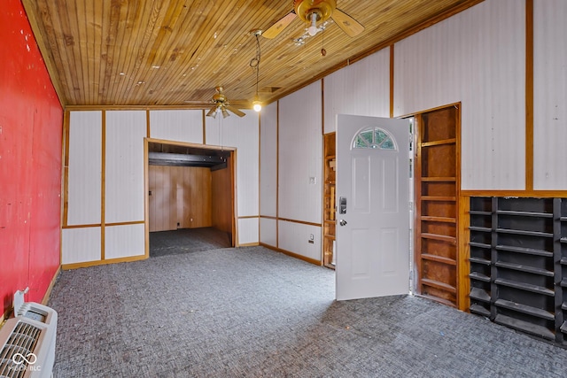 1310 California St, Columbus, IN 47201 - basement featuring ceiling fan, wooden ceiling, carpet, heating unit, and wooden walls