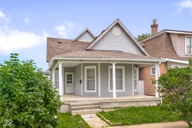 1310 California St, Columbus, IN 47201 - bungalow-style house featuring covered porch and roof with shingles
