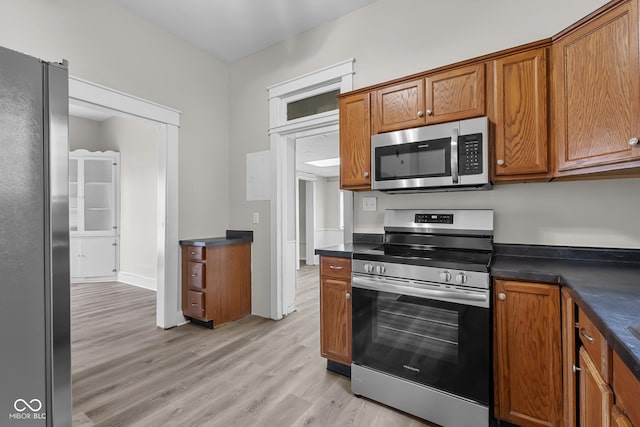 1310 California St, Columbus, IN 47201 - kitchen with appliances with stainless steel finishes, dark countertops, and brown cabinets
