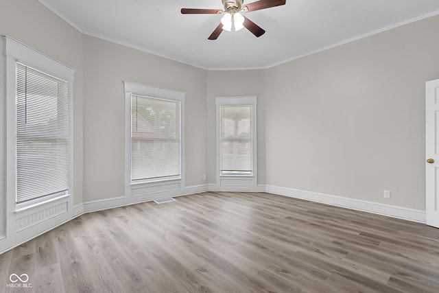 1310 California St, Columbus, IN 47201 - empty room featuring wood finished floors, ceiling fan, and crown molding