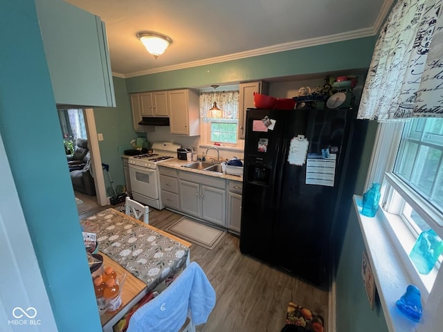 111 S Jefferson St, Brownsburg, IN 46112 - kitchen with white gas range oven, black fridge with ice dispenser, crown molding, under cabinet range hood, and light wood finished floors