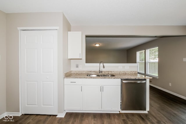 8310 Becks Mill Ln, Indianapolis, IN 46113 - kitchen with stainless steel dishwasher, dark wood-style floors, white cabinets, light stone counters, and a peninsula