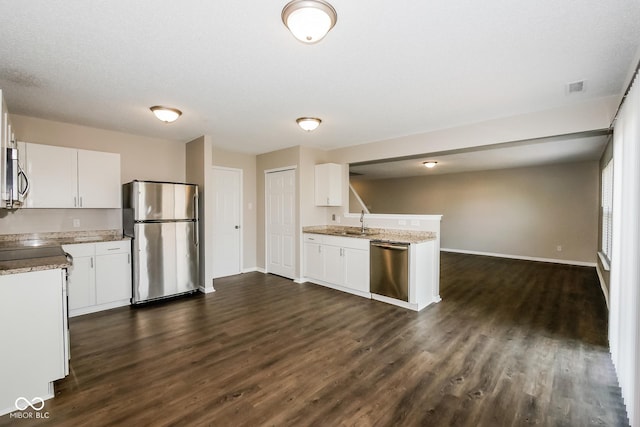 8310 Becks Mill Ln, Indianapolis, IN 46113 - kitchen with stainless steel appliances, dark wood-type flooring, a peninsula, and white cabinets