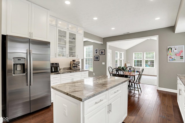 9653 Cypress Way, Carmel, IN 46032 - kitchen with stainless steel fridge with ice dispenser, light stone countertops, vaulted ceiling, dark wood-style flooring, and glass insert cabinets