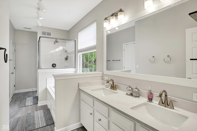 9653 Cypress Way, Carmel, IN 46032 - full bath featuring a stall shower, a garden tub, double vanity, and wood finished floors