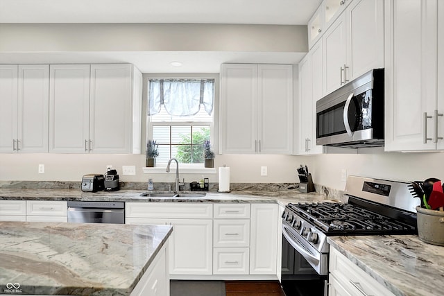 9653 Cypress Way, Carmel, IN 46032 - kitchen with stainless steel appliances, white cabinets, and light stone counters