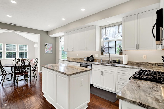 9653 Cypress Way, Carmel, IN 46032 - kitchen with white cabinets, a kitchen island, dark wood-style flooring, recessed lighting, and light stone counters