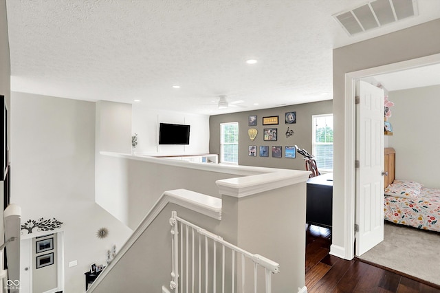 9653 Cypress Way, Carmel, IN 46032 - hallway with an upstairs landing, dark wood finished floors, recessed lighting, and a textured ceiling