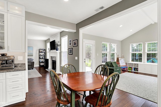 9653 Cypress Way, Carmel, IN 46032 - dining space featuring dark wood-style floors, a fireplace with raised hearth, and recessed lighting