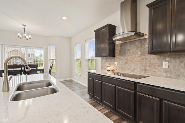 10811 Wild Orchard Ln, Indianapolis, IN 46239 - kitchen with island exhaust hood, black electric cooktop, decorative backsplash, dark wood-type flooring, and dark brown cabinetry