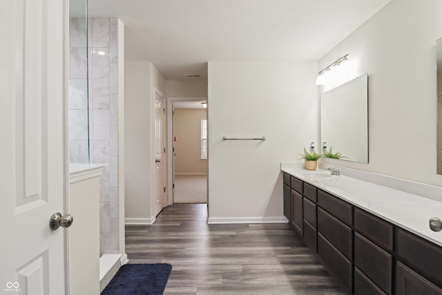 10811 Wild Orchard Ln, Indianapolis, IN 46239 - bathroom with vanity, wood finished floors, and a tile shower
