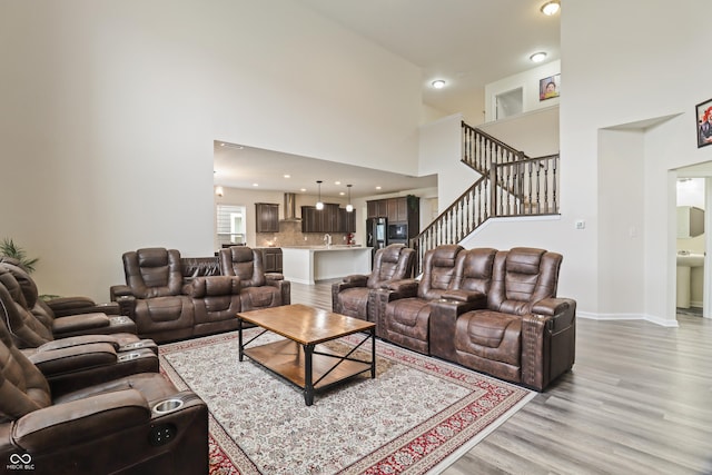 10811 Wild Orchard Ln, Indianapolis, IN 46239 - living area with a high ceiling, light wood finished floors, and stairs