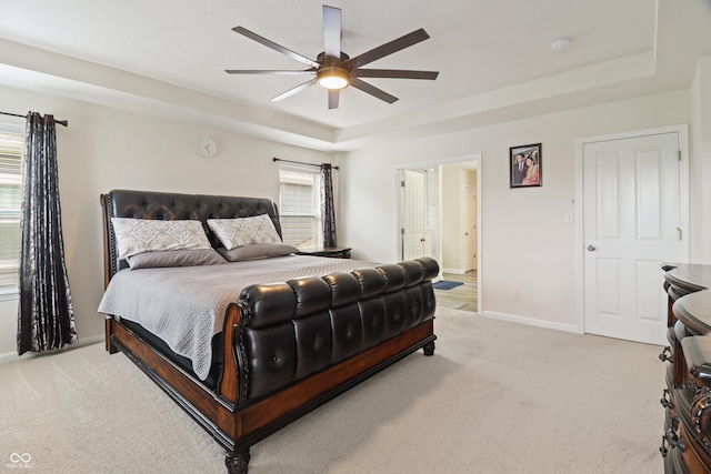 10811 Wild Orchard Ln, Indianapolis, IN 46239 - bedroom featuring light colored carpet, a tray ceiling, a ceiling fan, and ensuite bathroom