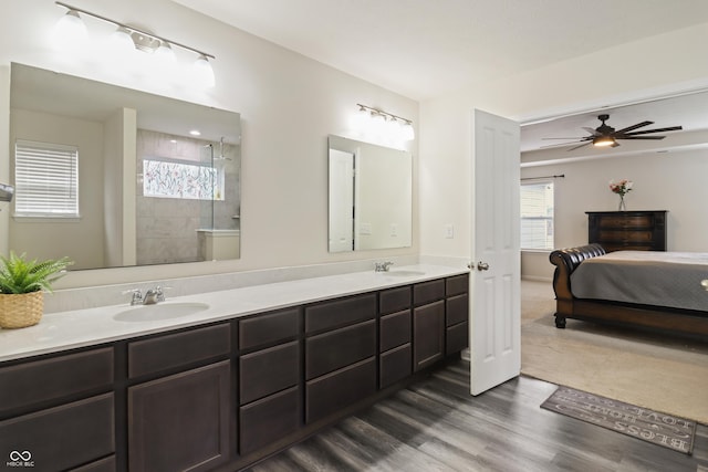 10811 Wild Orchard Ln, Indianapolis, IN 46239 - ensuite bathroom with double vanity, wood finished floors, tiled shower, and ceiling fan