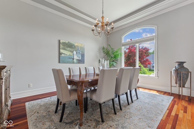 4396 W Eagle Trce, New Palestine, IN 46163 - dining space featuring a chandelier, ornamental molding, wood finished floors, and a raised ceiling