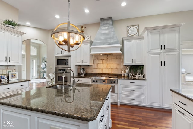 4396 W Eagle Trce, New Palestine, IN 46163 - kitchen featuring custom range hood, arched walkways, a chandelier, stainless steel appliances, and dark wood-type flooring