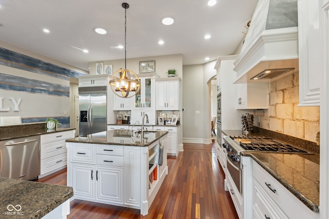4396 W Eagle Trce, New Palestine, IN 46163 - kitchen featuring stainless steel appliances, premium range hood, arched walkways, backsplash, and white cabinets