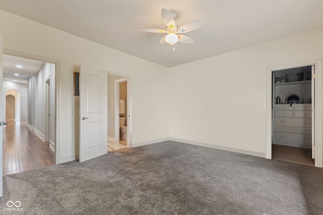 4396 W Eagle Trce, New Palestine, IN 46163 - unfurnished bedroom with carpet floors, arched walkways, and a spacious closet