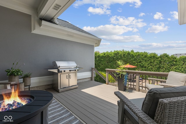 4396 W Eagle Trce, New Palestine, IN 46163 - wooden terrace with grilling area and an outdoor fire pit