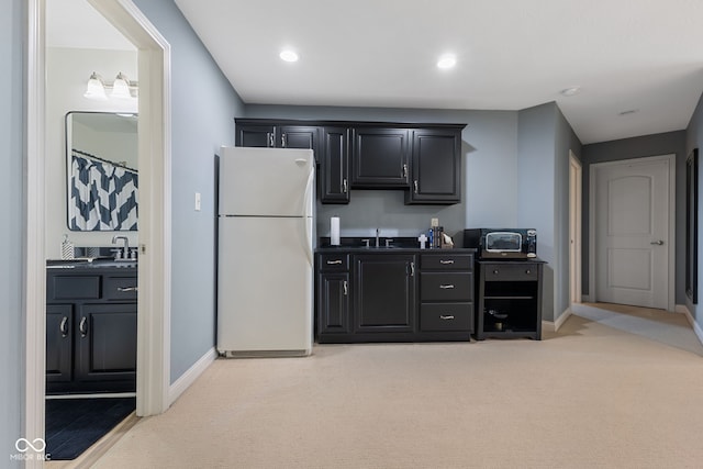 4396 W Eagle Trce, New Palestine, IN 46163 - kitchen featuring freestanding refrigerator, light carpet, dark countertops, dark cabinetry, and recessed lighting
